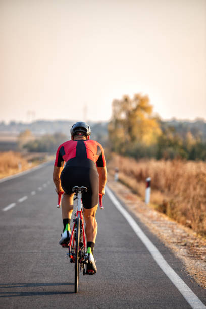 istock Athlete man riding bicycle on the road 1185195745
