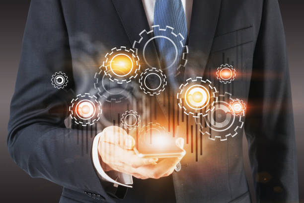 istock Businessman with smartphone, gears and graph 1185196904