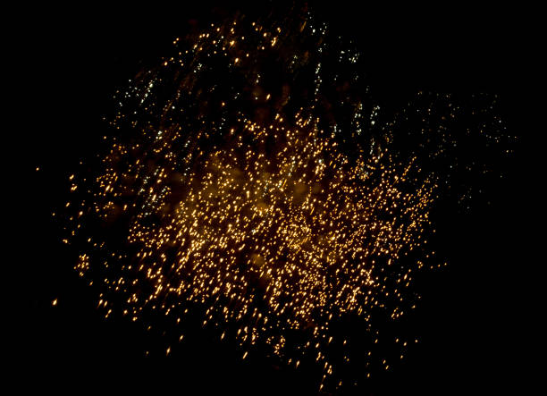 istock Light golden Sparkle fireworks for celebrations on black background 1185197265