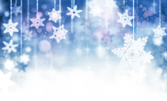 Hanged snowflakes over blue gradient background