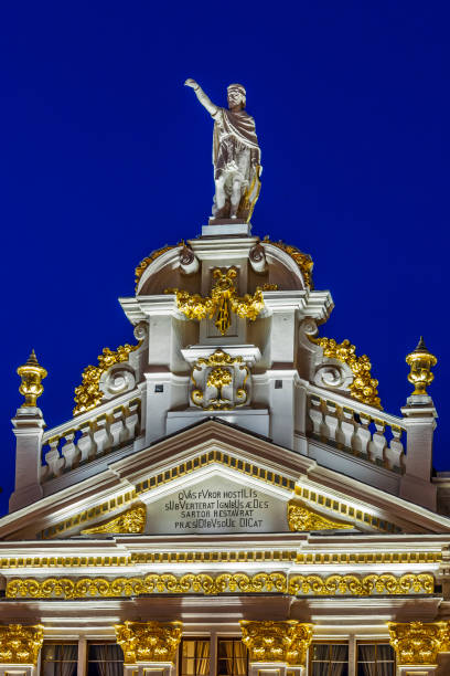 Statues and decorations on the top of a building overlooking the Grand Place