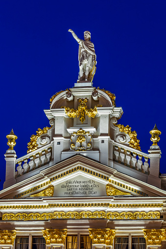 Statues and decorations on the top of a building overlooking the Grand Place