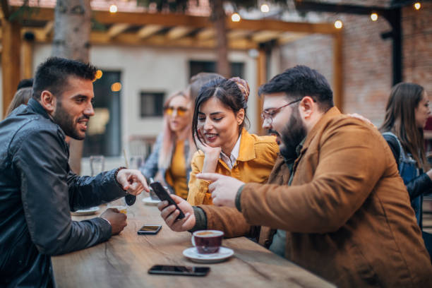 istock Young joyful friends having fun in a pub 1185199355