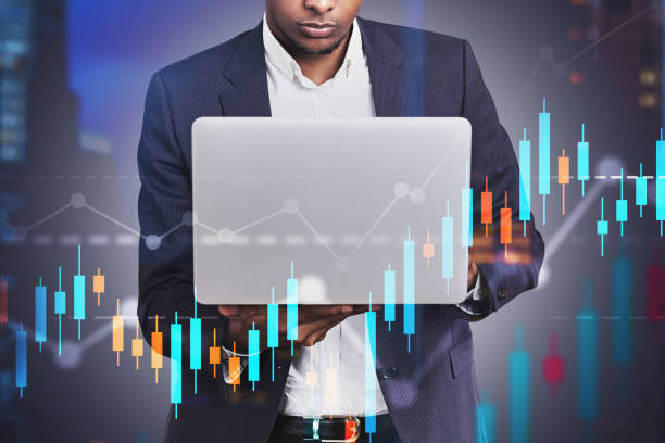 istock African American man with laptop, graph 1185199506