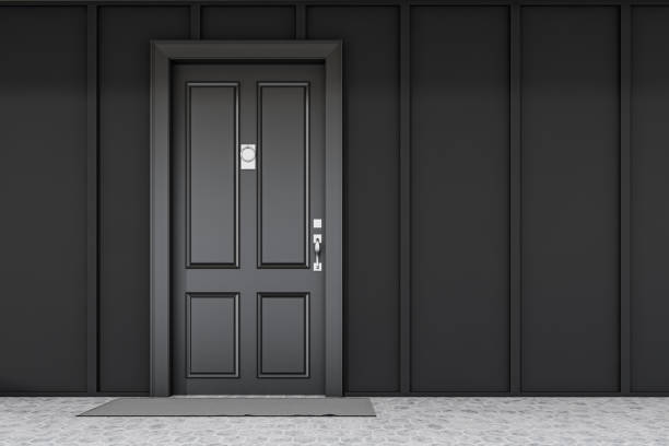 istock Black front door of black house with mat 1185199659
