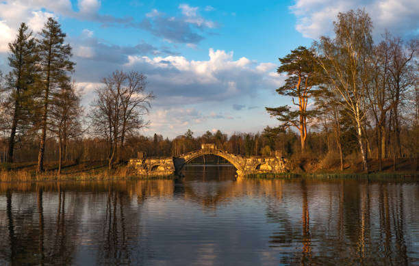 istock Ancient arched bridge over the lake at sunset. 1185199987