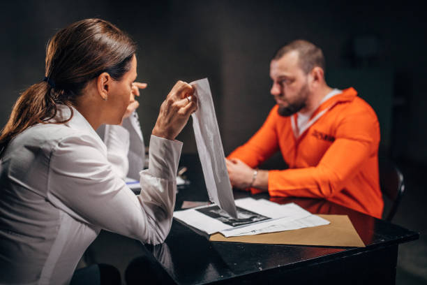 istock Prisoner and female detective 1185201052