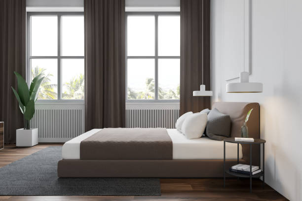 istock Side view of white bedroom with windows and TV 1185202591
