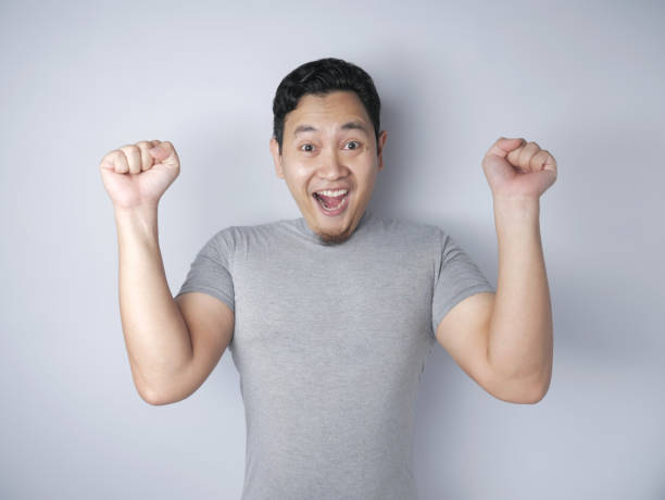 istock Funny Asian Man Shows Surprised Happy Expression 1185206319