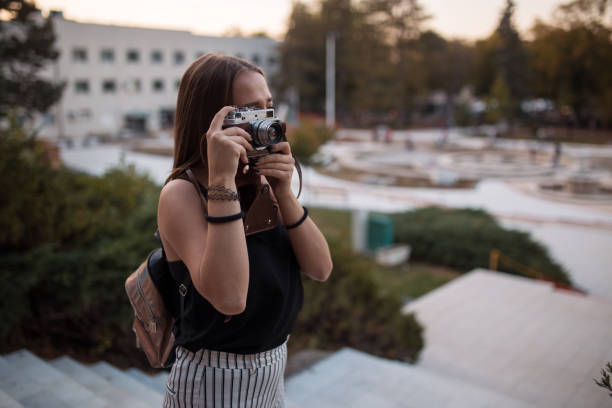 istock Young woman tourist with camera 1185206664