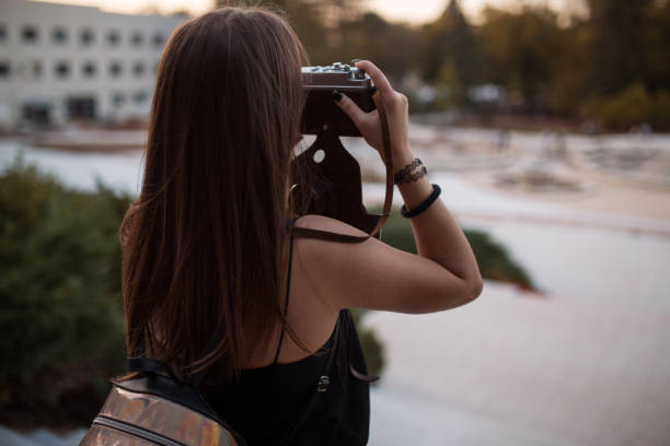 istock Young woman tourist with camera 1185206727