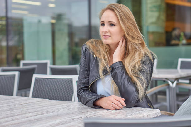 istock Girl sitting in front of cafe 1185207716