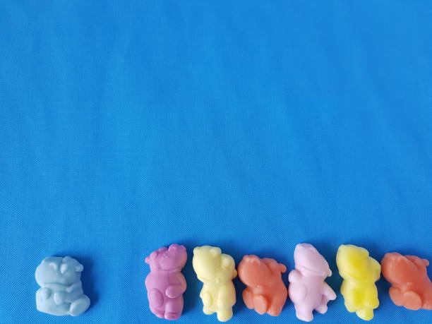 istock candy jelly hippos on a blue background of fabric 1185208128