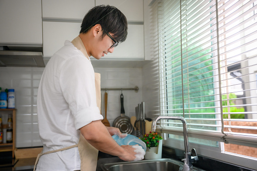 man or husband help homeworks washing or cleaning dishes after meals