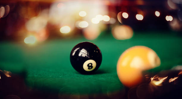 istock Billiard ball with number eight on a green billiard table. 1185211249