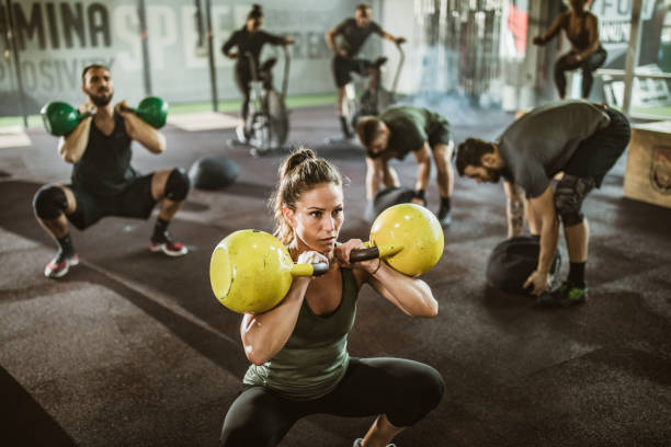 istock Large group of athletic people having gym training in a gym. 1185211471