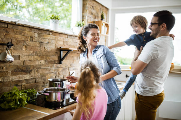 istock Happy family having fun while making lunch in the kitchen. 1185216193