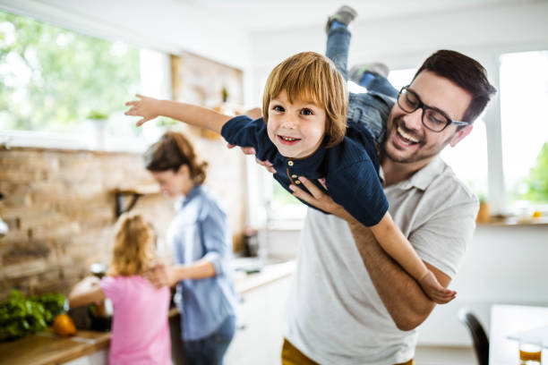 istock Happy boy having fun with his father in the kitchen. 1185216320