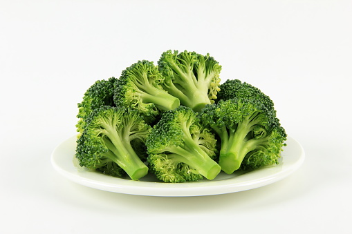A plate of broccoli on white background