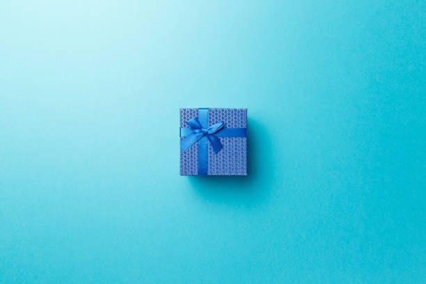 istock Blue gift box with blue ribbon on blue background. Top view. Flat lay. Copy space. Colorful background. Minimal christmas new year creative concept. Trendy pastel color 1185219434