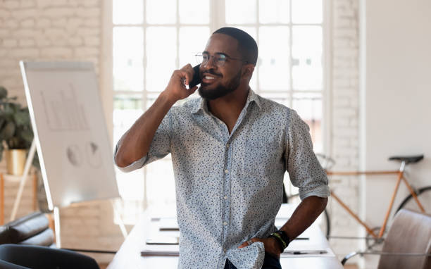 istock Successful millennial mixed race businessman holding mobile phone call. 1185220703