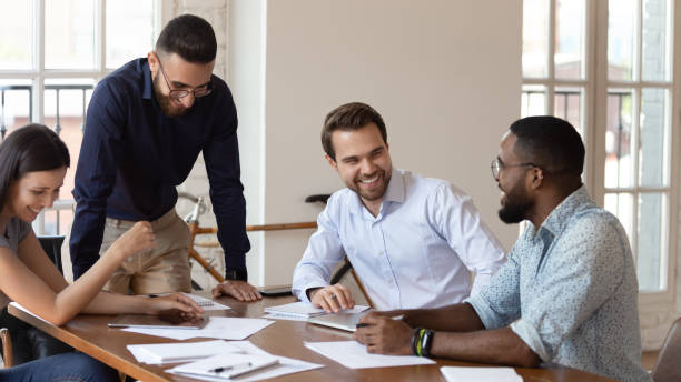 istock Happy mixed race colleagues laughing at jokes, having fun. 1185220742