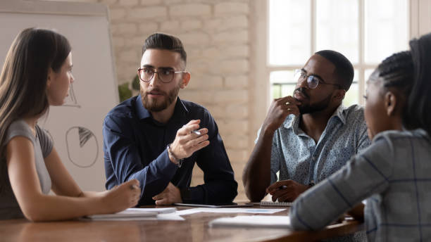 istock Concentrated young mixed race business partners discussing development strategy. 1185220745
