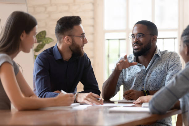 istock Mixed race young business people discussing working issues. 1185220752