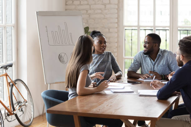 istock Happy diverse group of employees working at creative office. 1185220756