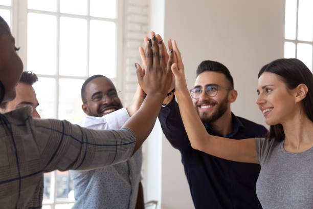 istock Overjoyed multiracial young business team members giving high five. 1185220773