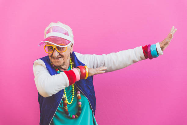 Funny grandmother portraits. 80s style outfit. trapstar taking a selfie on colored backgrounds. Concept about seniority and old people Funny grandmother portraits. 80s style outfit. trapstar taking a selfie on colored backgrounds. Concept about seniority and old people dab dance photos stock pictures, royalty-free photos & images