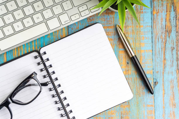 Flat lay composition of book, fountain pen, plant and glasses on the wooden table top view Minimalist flat lay composition of book, fountain pen, plant and glasses on the wooden table top view fountain pen pattern writing instrument pen stock pictures, royalty-free photos & images