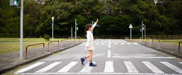 istock Child crossing the pedestrian crossing 1185222398