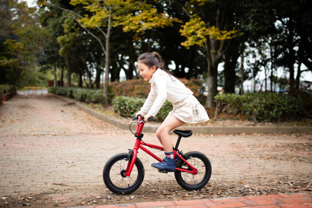 istock Girl playing on a red bicycle 1185222416