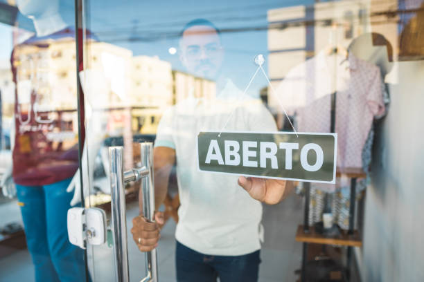 istock Salesman opening the clothing store 1185223919