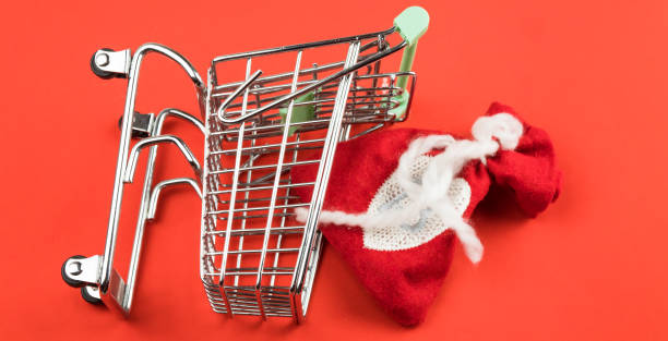 istock red christmas bag in trolley on red background. Christmas composition. 1185224525