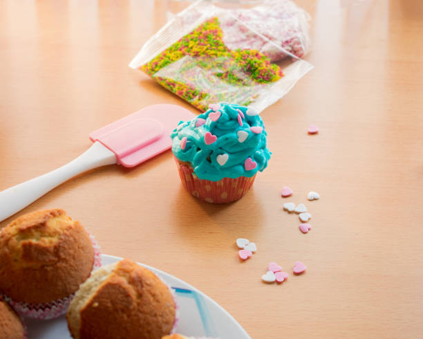 istock cupcake with blue cream topping and hearts 1185225051