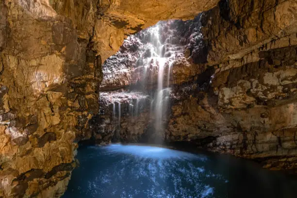 Photo of Smoo Cave, a large combined sea and freshwater cave with a waterfall in Durness, Sutherland, Highland, Scotland.