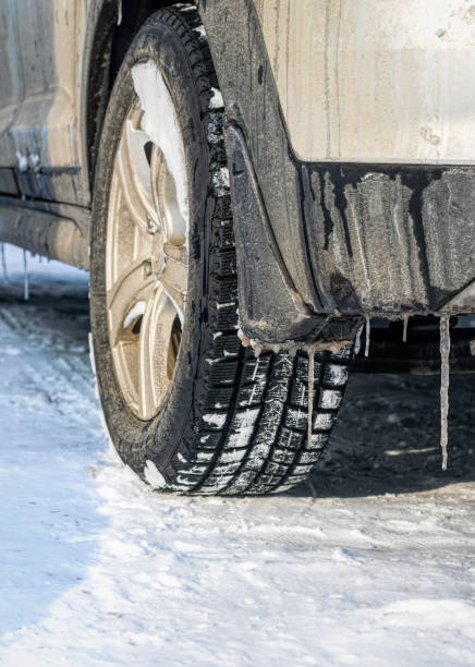 istock New winter car tire. Safe winter driving 1185226359