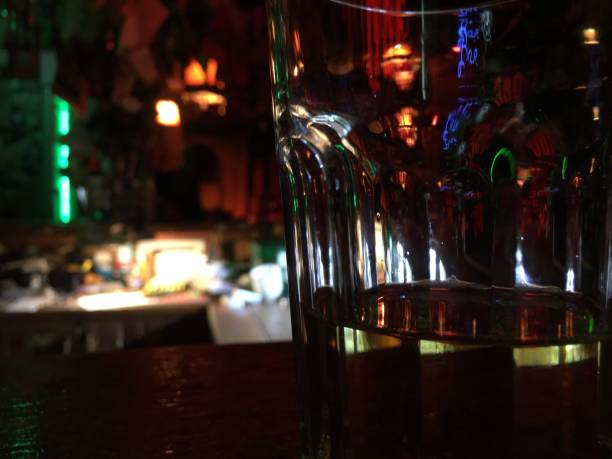 istock Highball glass is visible in the reflection of objects in the bar, shell colors and light.  background wallpaper 1185228981