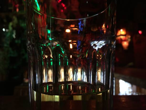 istock Highball glass is visible in the reflection of objects in the bar, shell colors and light.  background wallpaper 1185229029