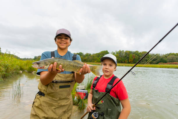 istock Two brothers with a pickerel or walleye fish they have caught. 1185229326