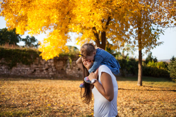 istock Mother with daughter enjoying autumn day 1185230352