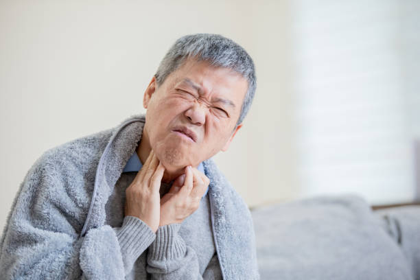 istock elderly man has sore throat 1185230478