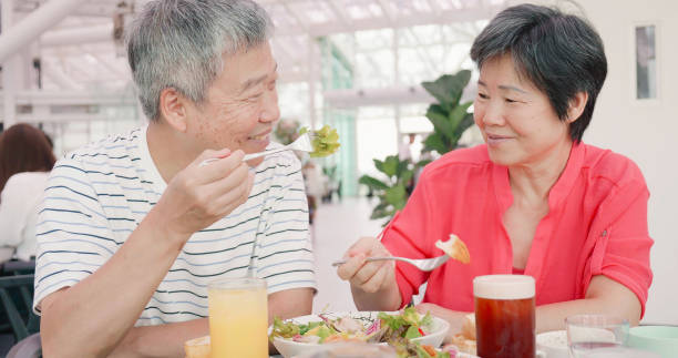 istock elder couple eating in restaurant 1185231526
