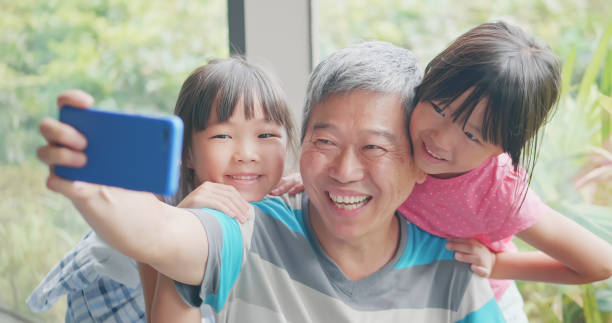 istock grandfather take selfie with kids 1185231828