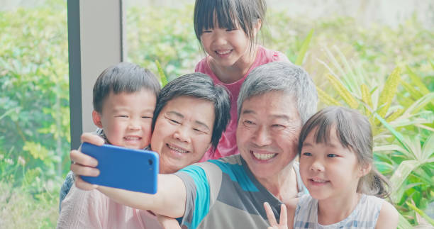 istock asian family take selfie 1185231849