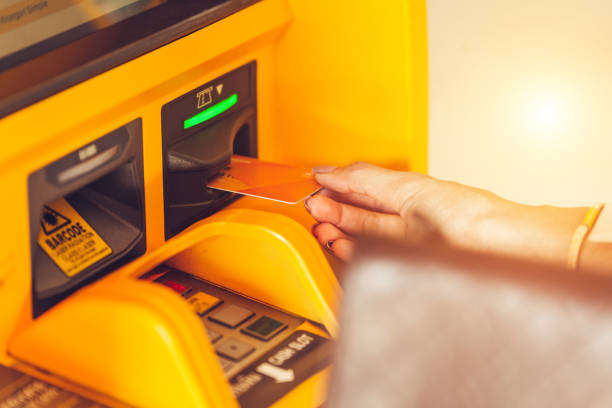 istock Young woman inserting a credit card to ATM 1185233227