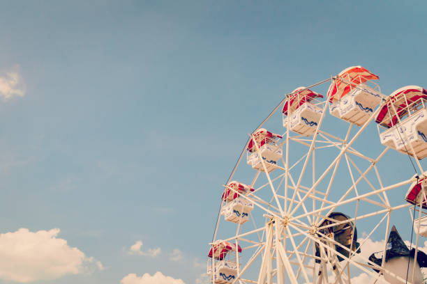 istock Ferris wheel on cloudy sky background with vintage toned. 1185235243