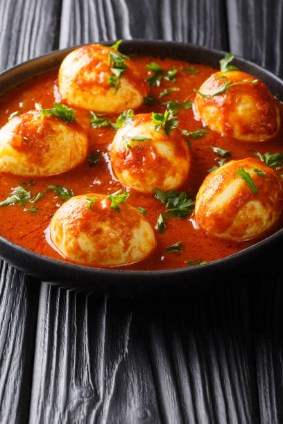 istock Boiled curry eggs in spicy sauce close-up in a plate. vertical 1185235904